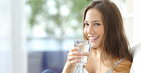 Girl drinking water at home